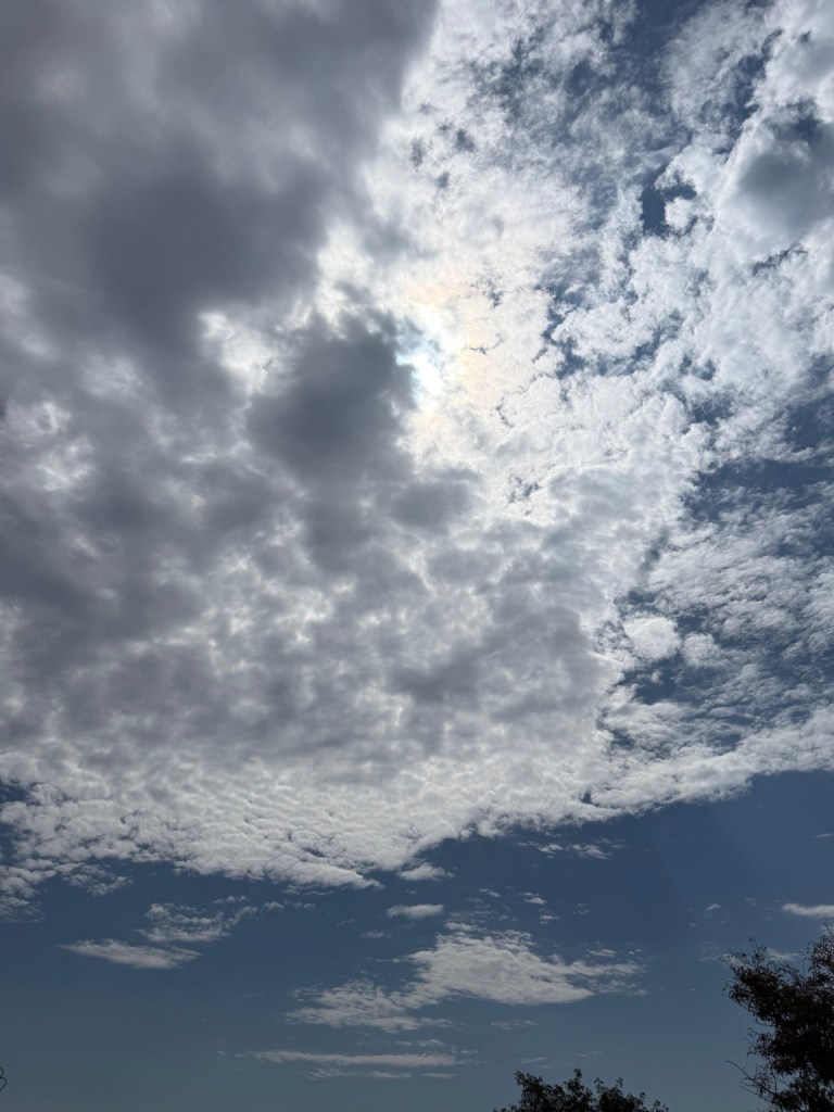Sky over Lee's Summit, Missouri at 12:55 PM on September 9, 2026, with dark clouds meeting bright textured clouds and blue sky.