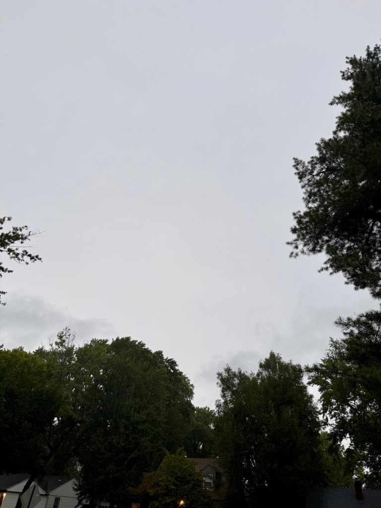 Pale gray stratiform cloud cover above trees in Raytown, Missouri at 7:20 AM on September 10, 2026.