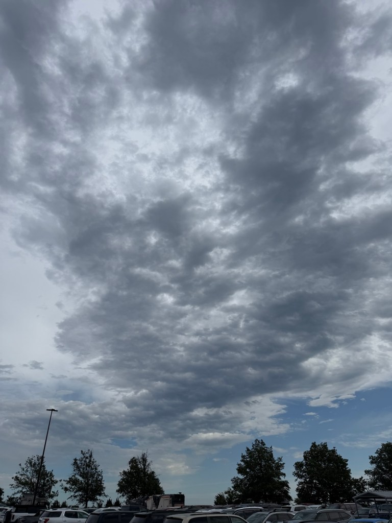 Sun glowing through a thin gray cloud layer at 4:10 PM