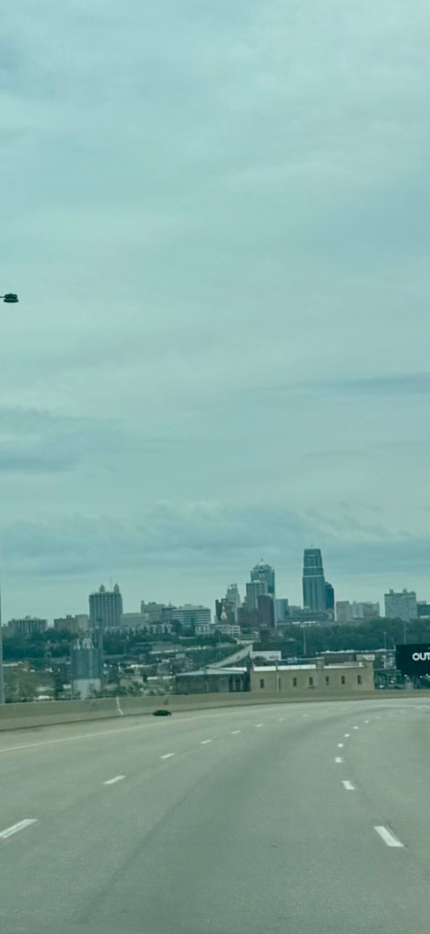 Downtown Kansas City skyline beneath a broad gray cloud deck