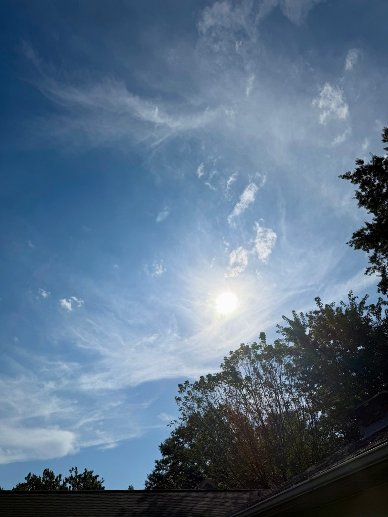 Sun shining through delicate high clouds over Raytown at 10:08 AM