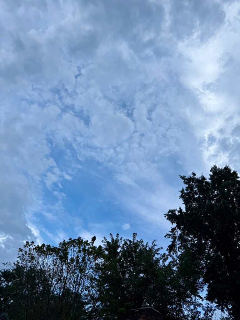 Layered gray evening clouds spreading across the sky in Raytown
