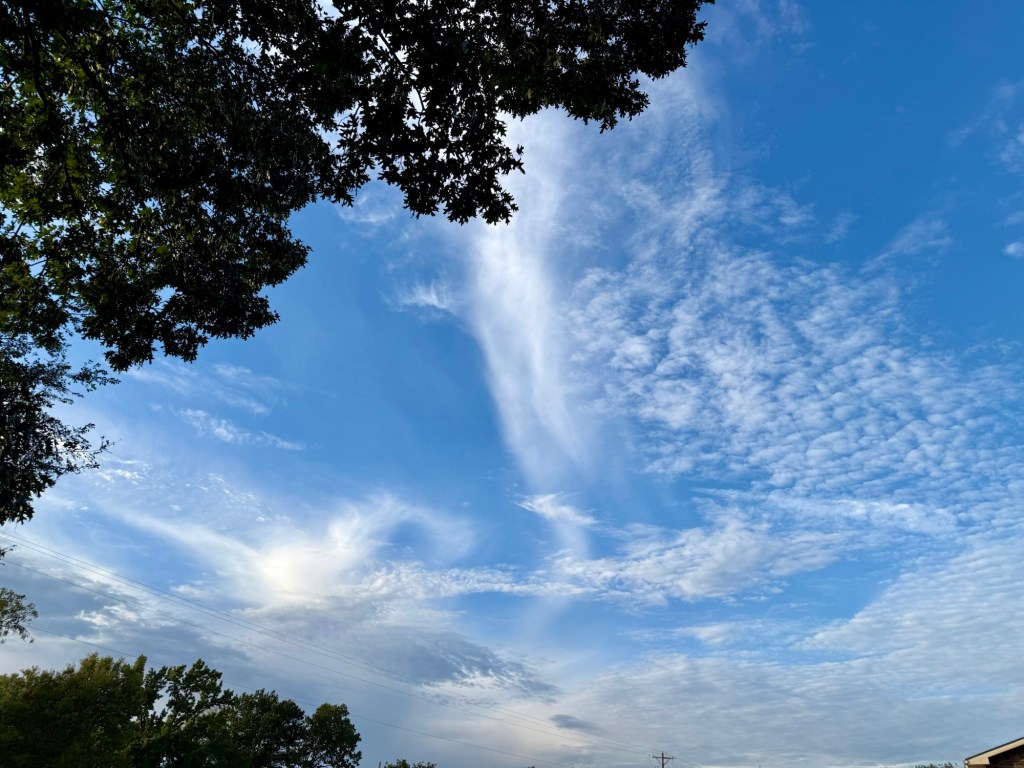 A large blue opening surrounded by rippled cloudlets and delicate high cloud streaks at 6:14 PM in Independence.