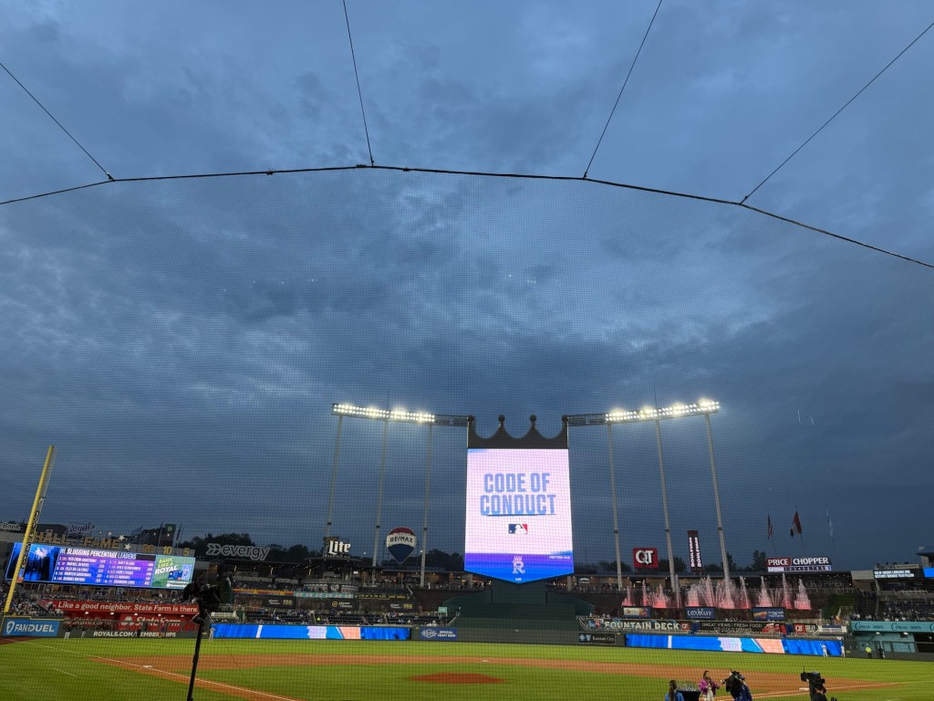 Blue-gray evening clouds over Kauffman Stadium at the start of a Kansas City Royals game