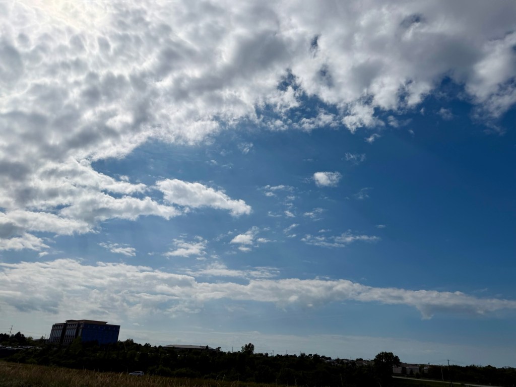 Deep blue sky with broken textured clouds and small cumulus over Raytown, Missouri