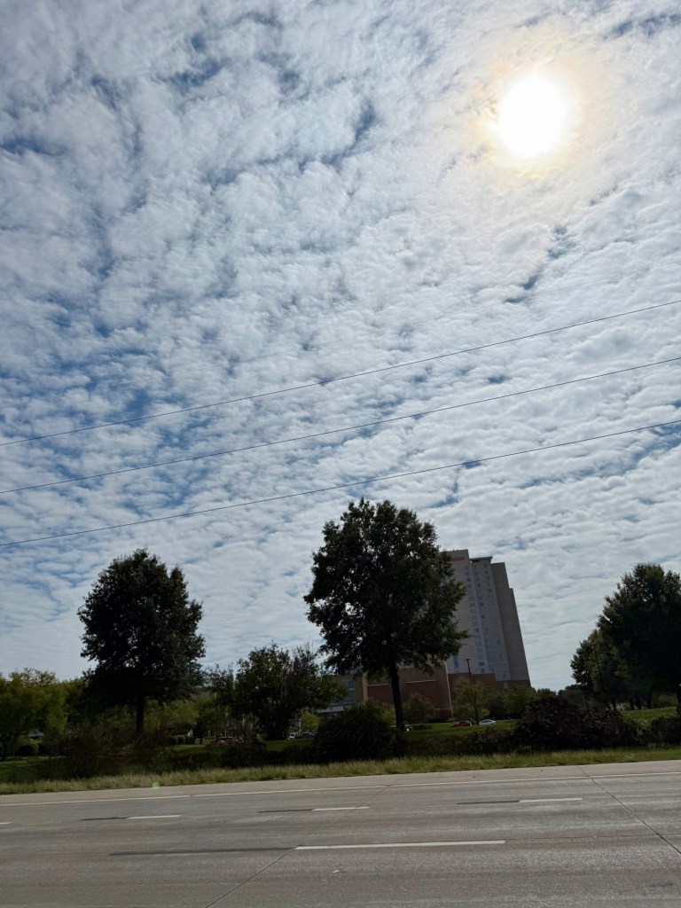 A textured cloud layer covering much of the sky with the sun shining through in Lenexa, Kansas