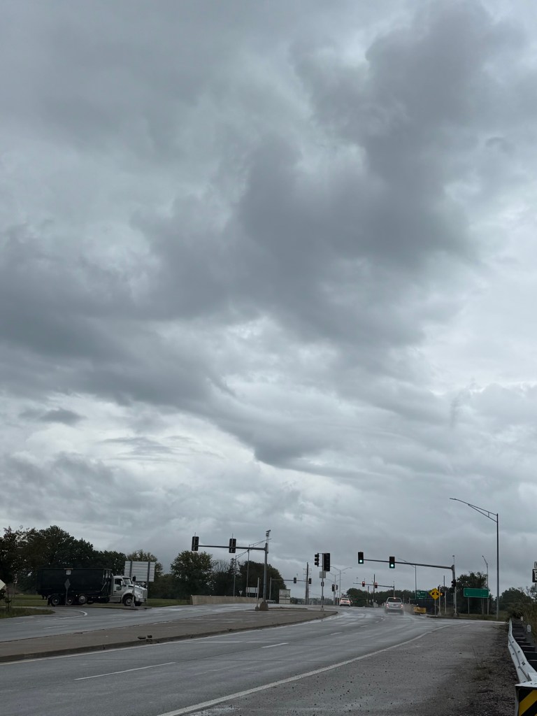 Rapidly changing low gray clouds over wet streets in Lee’s Summit