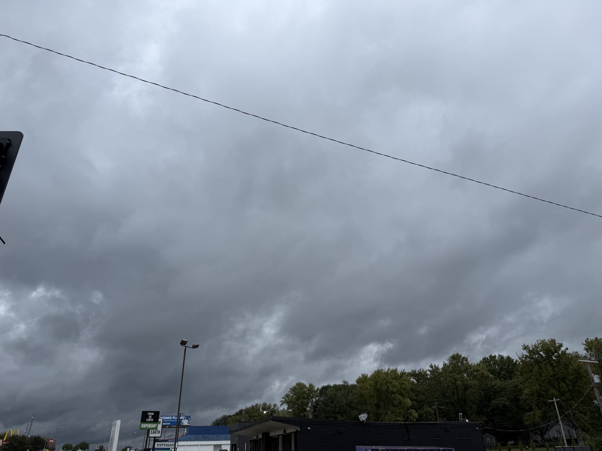 Dark gray clouds over an intersection in Raytown, Missouri at 1:49 PM