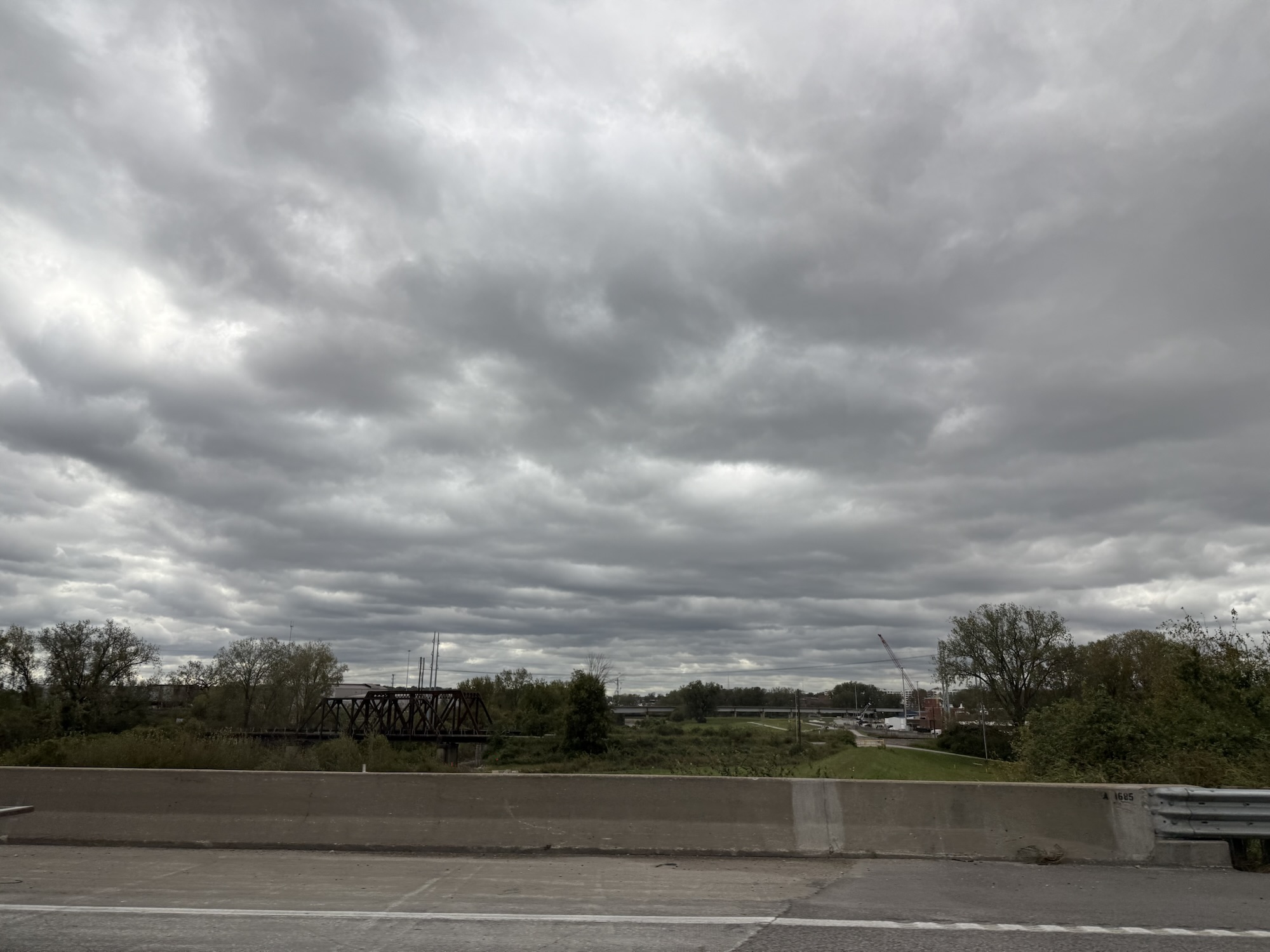 Wide stratocumulus cloud deck over railroad bridge near I-435