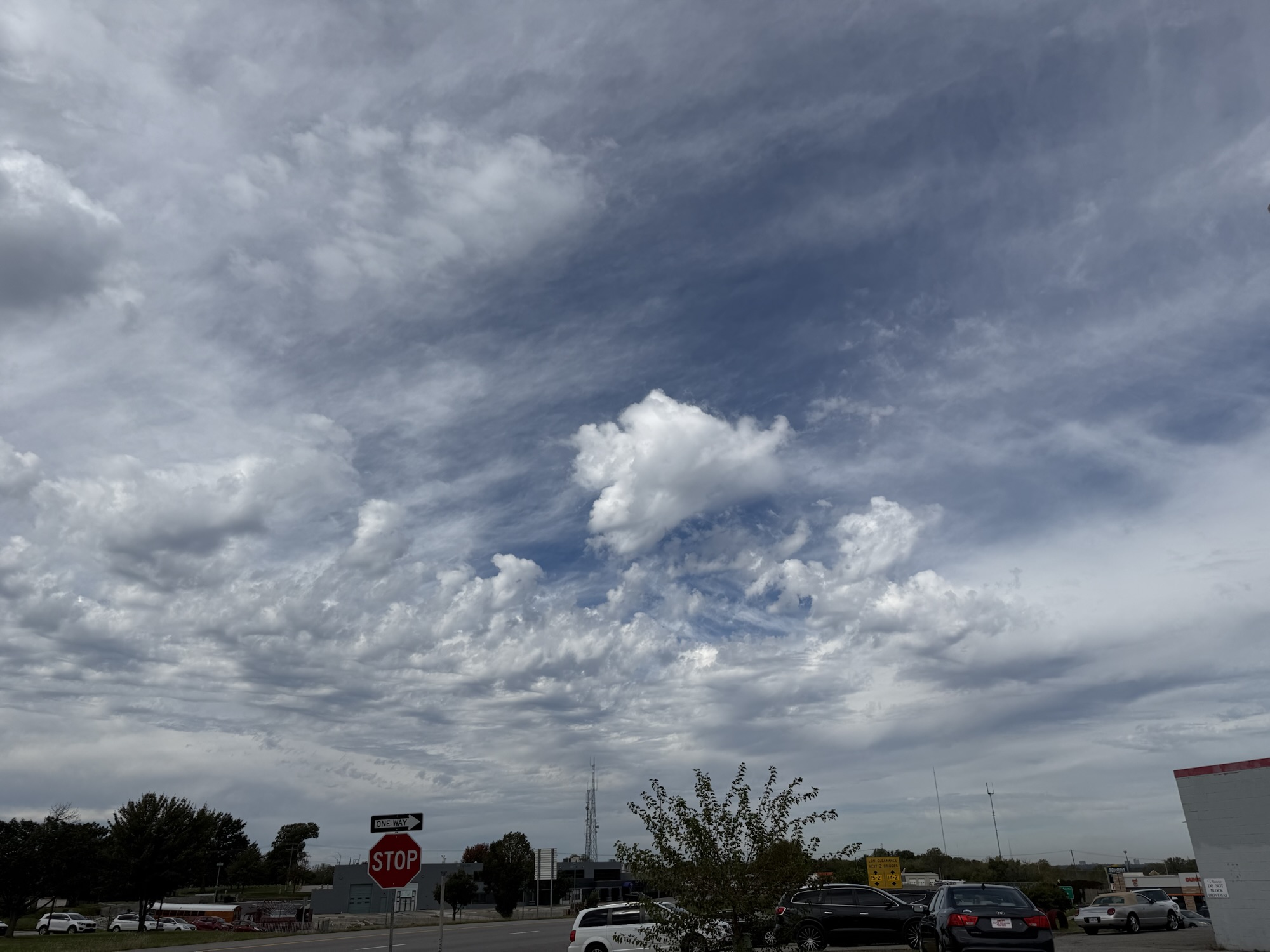 12:00 PM, Raytown: layered clouds above the neighborhood.