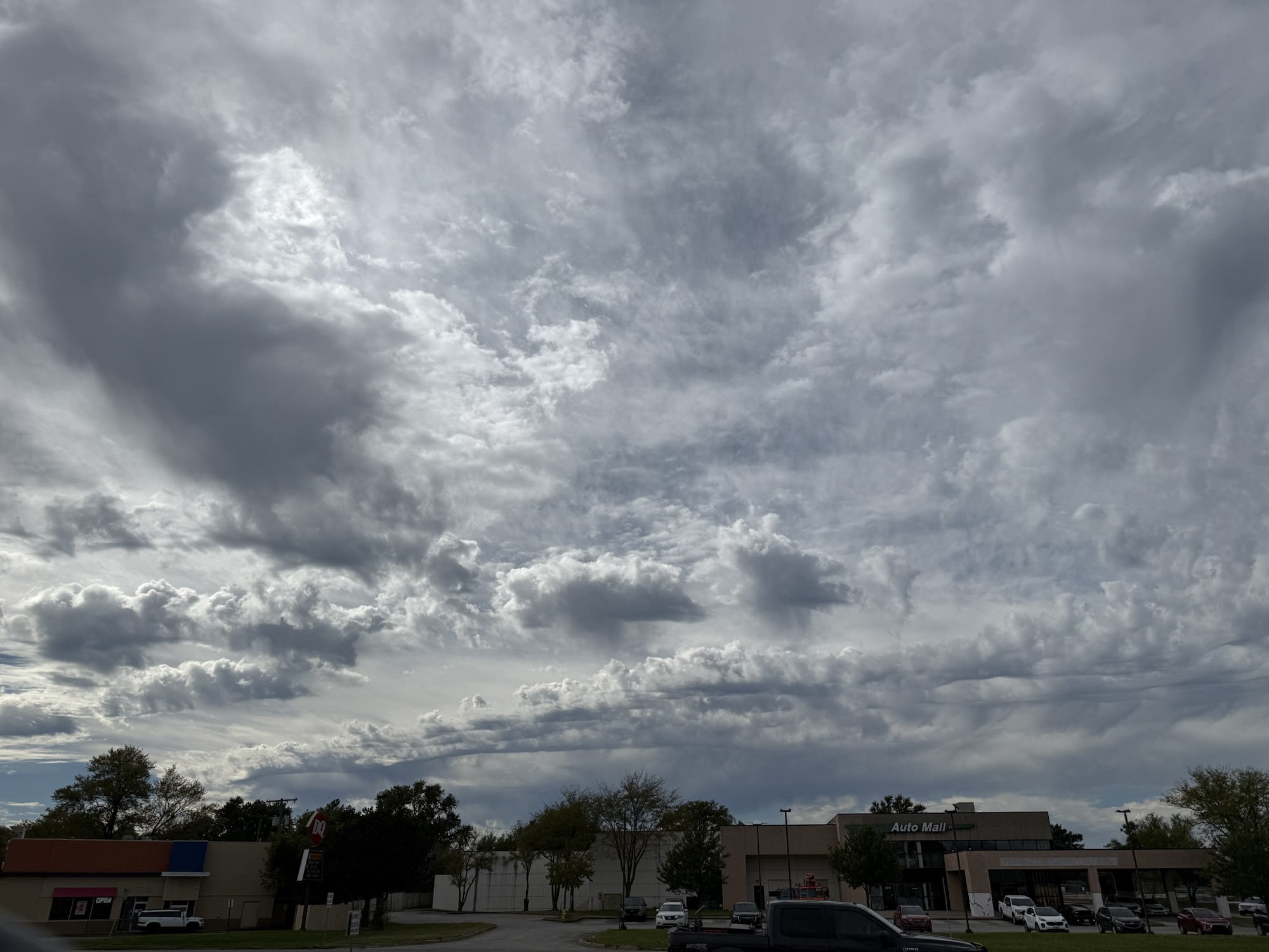 12:00 PM, Raytown: another direction reveals patches of blue and rounded clouds.
