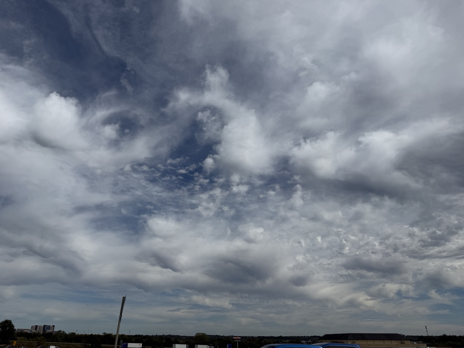 1:13 PM, Independence: blue sky framed by textured clouds.